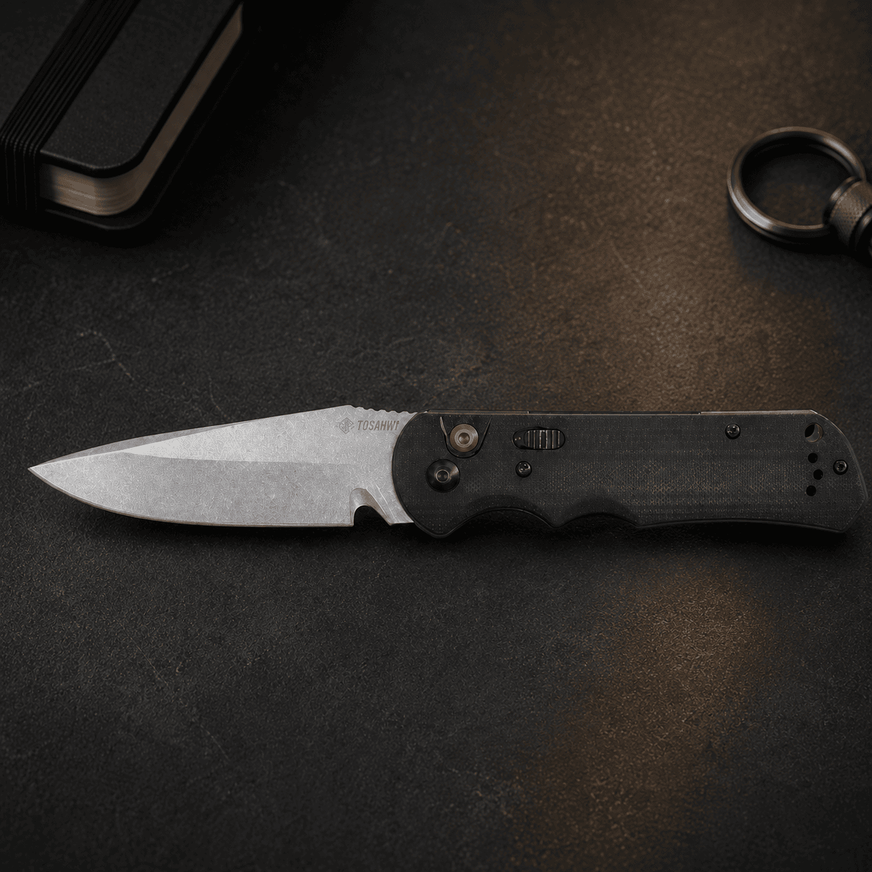 Tosahwi everyday carry pocket knife on a dark EDC work surface